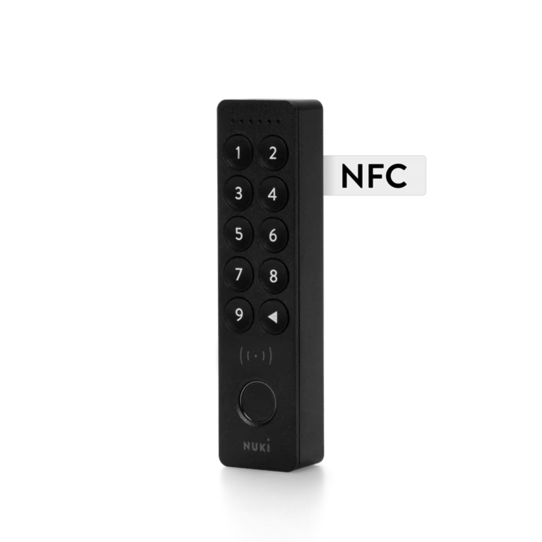 Black remote control with keypad and NFC label on a white background